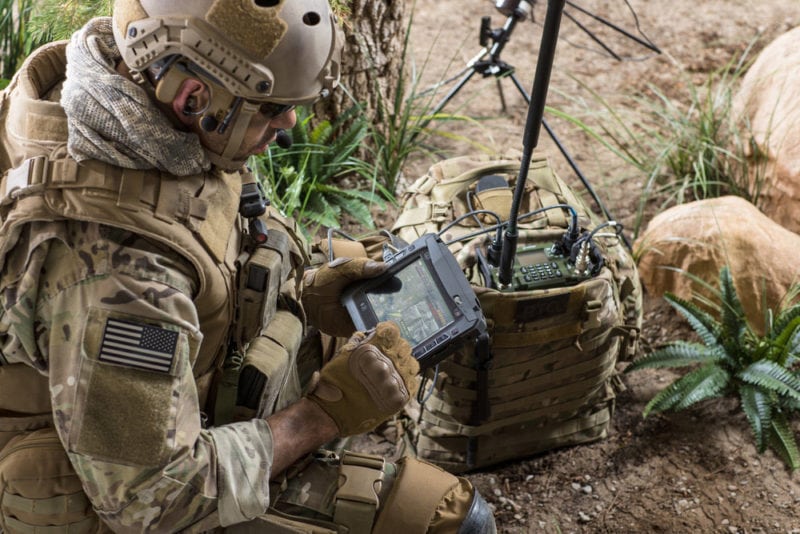 A soldier uses a radio with Harris's backpack.  Photo: Harris. 