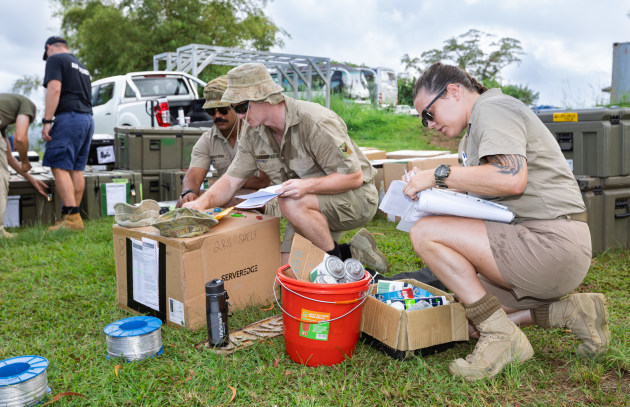 Australian Army soldiers (L-R) Private Osama Ahmed, Corporal Daniel Murphy and Private Hayley Freeman check equipment to support the Vanuatu National Government Emergency Radio Network upgrade. (Defence)
