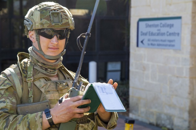 Australian Army Reserve soldier Private Joshua Thomson-Schmidt calls-in on a radio during a Stability Operations scenario at Shenton College as part of Exercise ARRAS held in Perth, WA. (Defence)