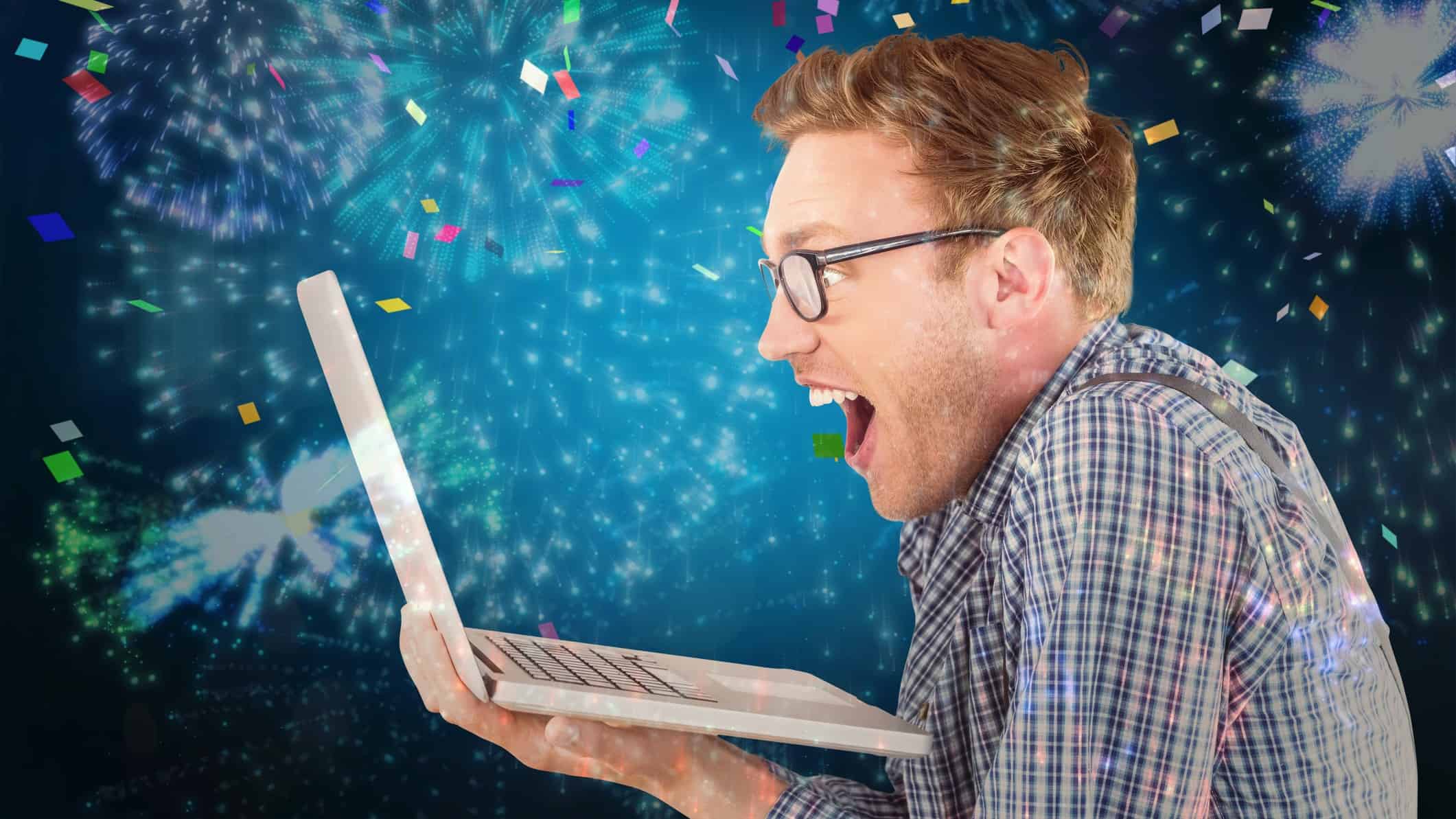 A man excitedly watches the rise in ASX stock prices on a computer screen against the backdrop of streamers